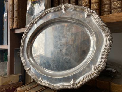 null Oval silver dish (750) with contoured edges surrounded by a frieze of crossed...