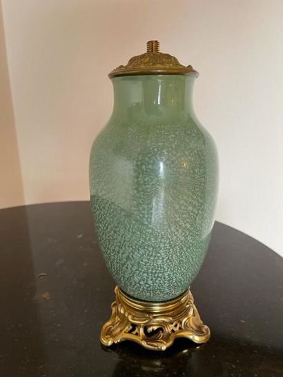 null SARREGUEMINES France.

Vase in green celadon cracked enamel, gilded and chased...