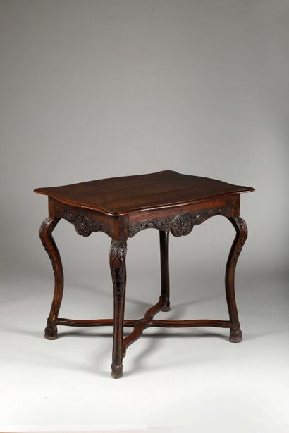 null Small rectangular table with contoured edges, in molded and carved oak decorated...