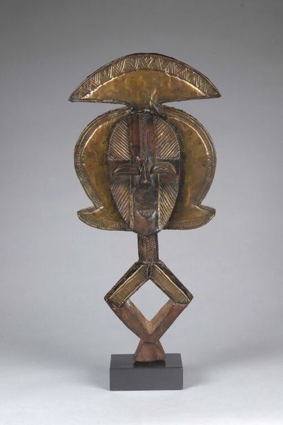 null Reliquary figure in wood plated with stapled brass leaves. The concave face...
