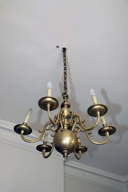 null Varnished brass chandelier with six arms of light around a sphere.
Mounted for...