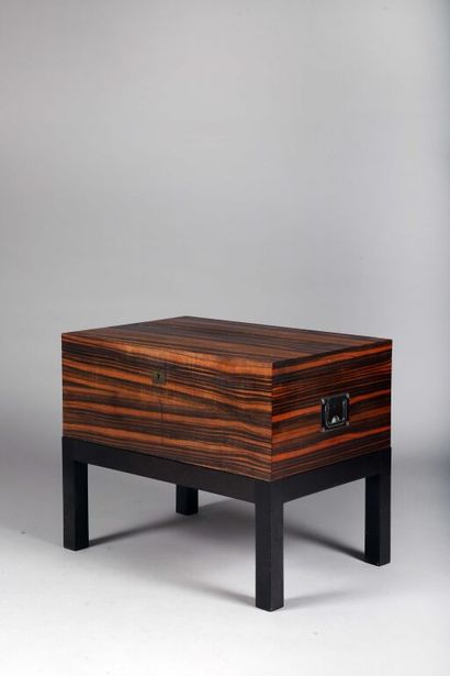 null Cigar cabinet on feet in Macassar ebony veneer opening to two compartmentalized...