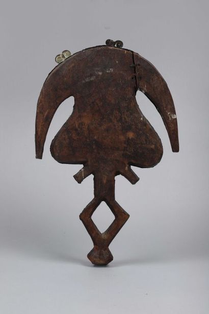 null Wooden reliquary figure representing a stylized character. The concave face...