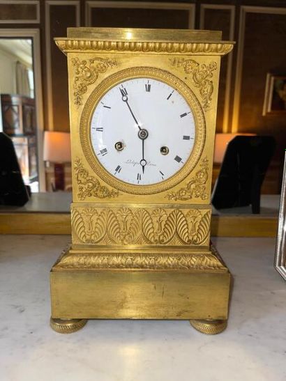 Small clock in chased and gilded bronze decorated...