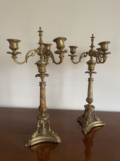 A pair of three-armed gilt bronze candelabras,...