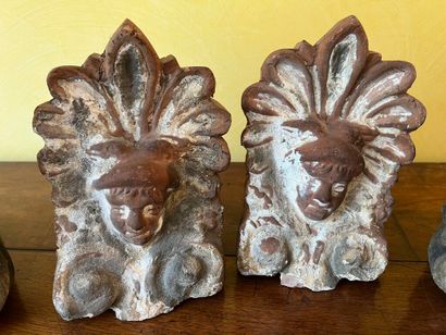null 2 pairs of terra cotta ridge tiles decorated with a Mercury head in a leafy...
