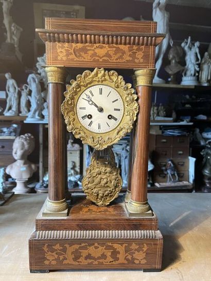 null Portico clock in wood and wood veneer with inlaid foliate decoration. 
Enameled...