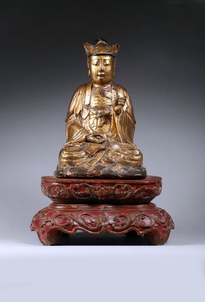 null CHINA.
Gold-lacquered wooden Buddha statuette depicted seated, eyes half-closed,...