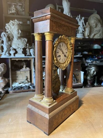 null Portico clock in wood and wood veneer with inlaid foliate decoration. 
Enameled...