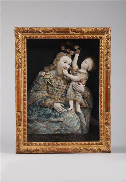 null Saint Joseph et l'Enfant Jésus.
Composition en plâtre polychrome en bas-relief,...