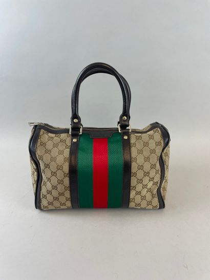 null GUCCI, Boston
33 cm brown leather handbag, monogrammed fabric with red and green...