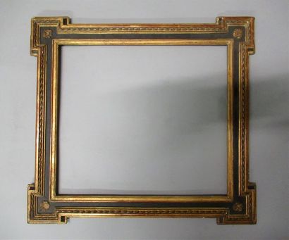 null Wooden frame and gilded stucco, blackened with ribboned stems and rosettes in...