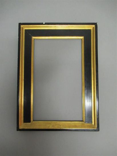 null Moulded, gilded and blackened wooden frame called "à édicule" with alternating...