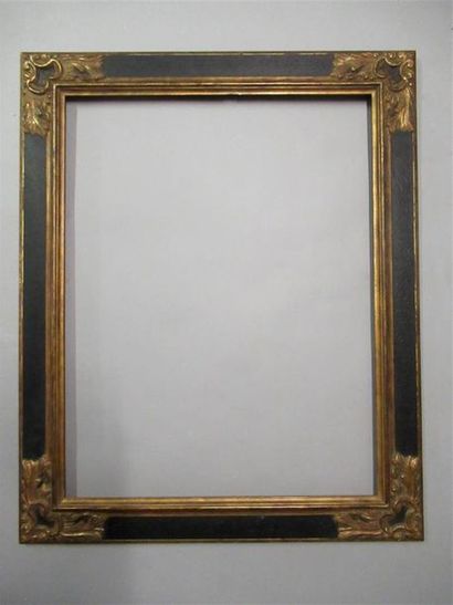 null Wooden frame and resin gilded and painted black with inverted profile and stylized...