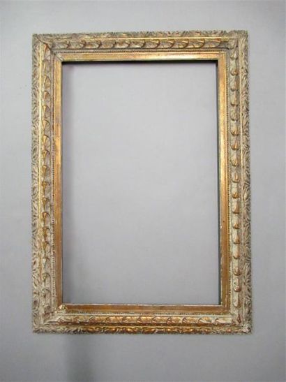 null Wooden frame and bleached gilded paste with an inverted profile with stylized...