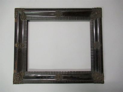 null Moulded wood frame, stained brown, black with wavy mouldings and applications...