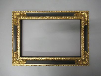 null Carved, gilded and black painted wood frame with an inverted profile and a stylized...