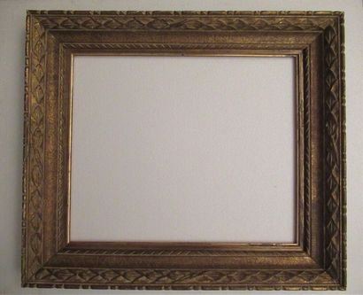 null Gilded and patinated carved wood frame called "Montparnasse" with stylized decoration...