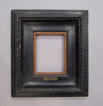 null Moulded wood frame, gilded with copper at the sight and blackened with a stylised...