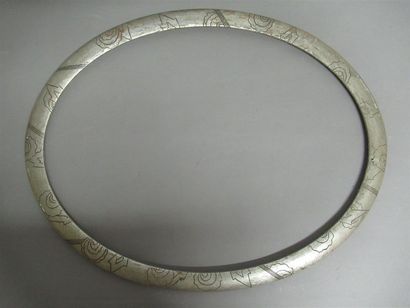 null Moulded wooden frame, silvered with an oval view decorated with geometrical...