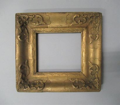 null Wooden frame and gilded paste, bronzed with stylized decoration and spandrels.
Italy,...