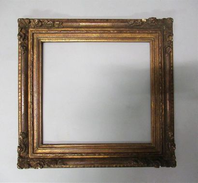 null Wooden frame with gilded and patinated stucco called "with flowered corners".
Louis...
