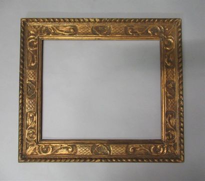 null Carved wood frame, gilded with copper and patinated with stylized decoration...