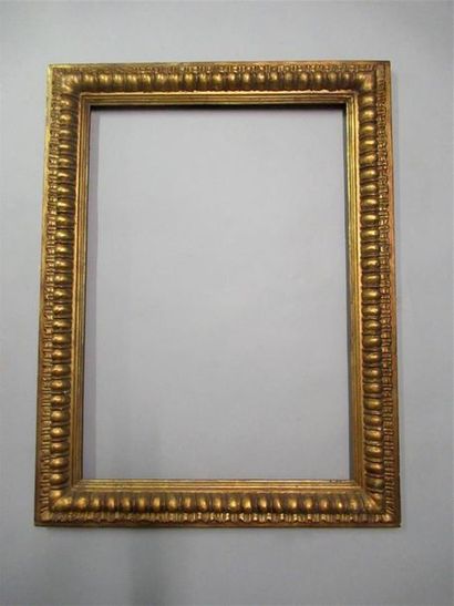 null Carved wood frame, gilded with an inverted profile and stylized decoration of...