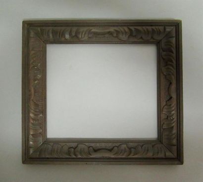 null Carved, stained and waxed natural wood frame with a frieze of stylized acanthus...