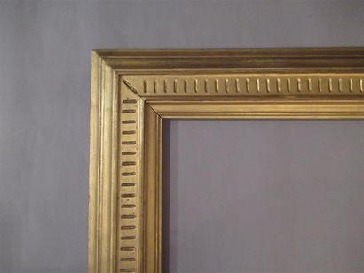 null Carved and gilded wood frame with inverted profile and burnished flutes.

Italy,...