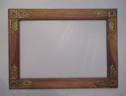 null A walnut or mahogany frame, moulded with a flat profile, decorated with brass...