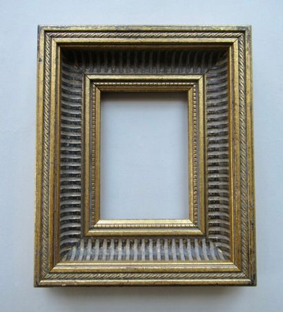 null Gilded wood and resin frame, with a patina called "à canaux" with stylized decorations...