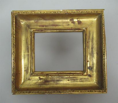null A carved, moulded and gilded pinewood frame with a wide groove profile and a...