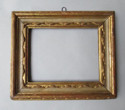 null A carved, gilded and painted white/grey wood frame with stylized festoons and...