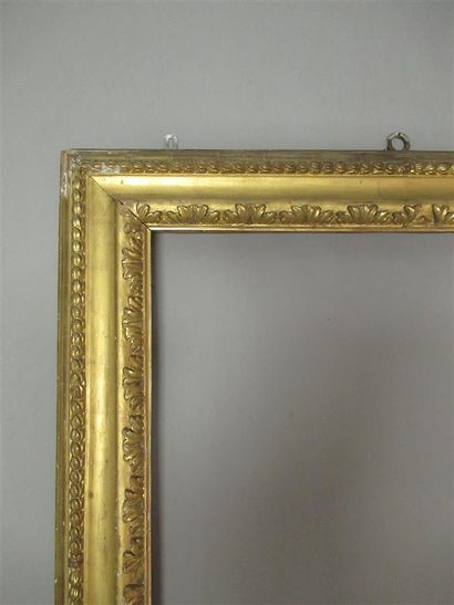 null A large carved pine frame with inverted profile and stylized acanthus leaves...