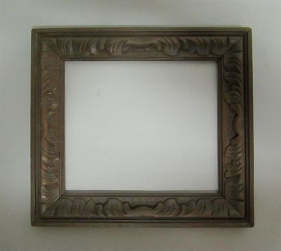 null Carved, stained and waxed natural wood frame decorated with a frieze of stylized...