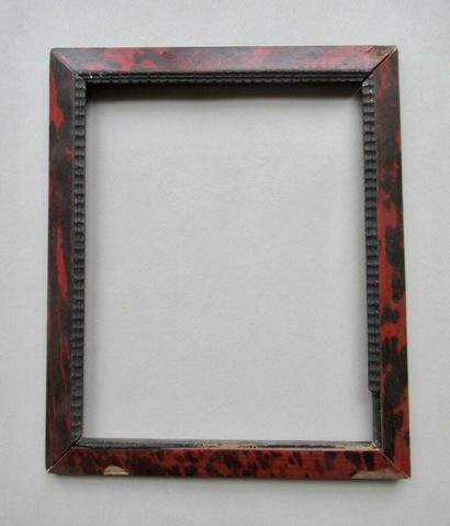 null Wooden frame veneered with red tortoiseshell and blackened wavy mouldings on...