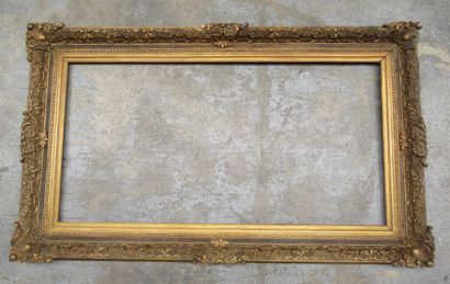 null Large wood and stucco frame with copper gilding and patina called "à décor Berain"...