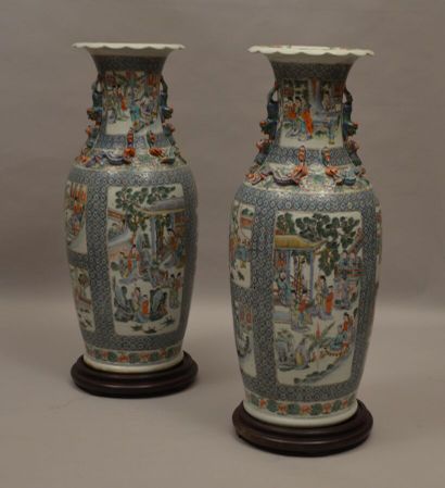 null Pair of porcelain vases decorated with animated scenes and salamanders in relief....