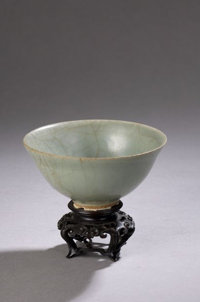 null Stoneware bowl with short heel and flared wall, with celadon cover. Small chips...
