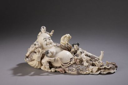 null Carved ivory subject enhanced with ink, Budai reclining on the bag of riches,...