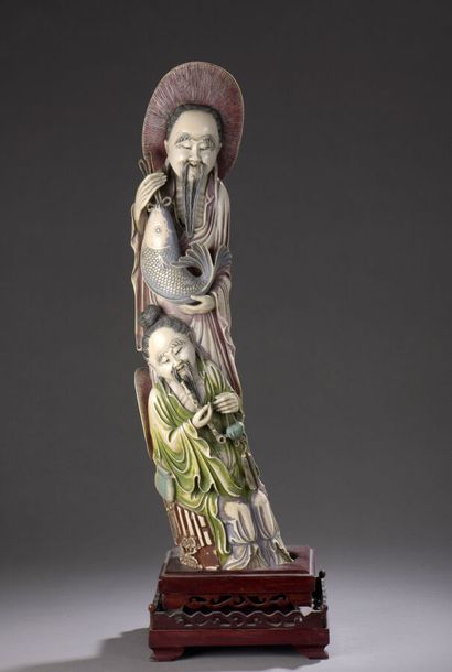 null Statuette in carved polychrome ivory, representing a fisherman standing, his...