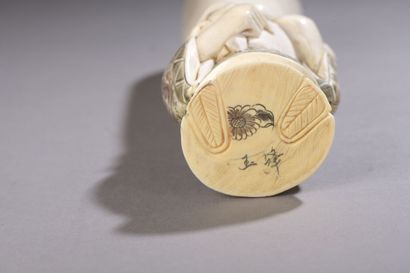 null Carved ivory okimono with ink highlights, Fukurukuju standing with an extremely...