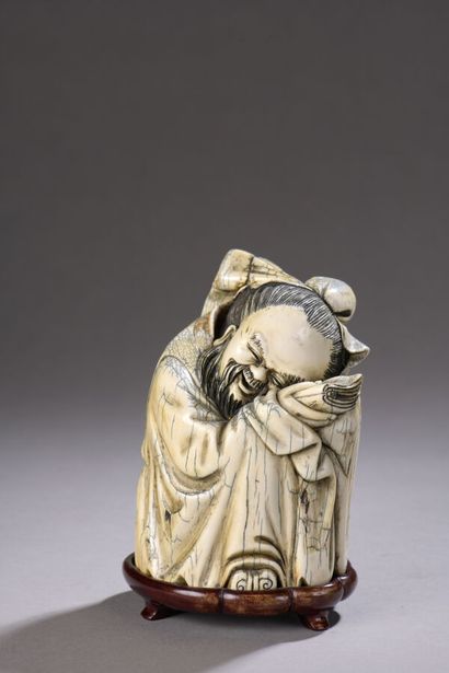 null Carved ivory subject enhanced with ink, crouching and sleeping Immortal. Artificial...