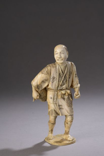 null Okimono in carved ivory and heightened with ink, standing character, a basket...