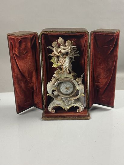 null Porcelain clock decorated with muse and cherubs, movement of Giminili Lantes...