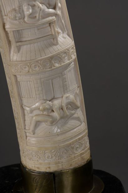 null Tusk in carved ivory with erotic themes. Metal frame, base in the shape of an...