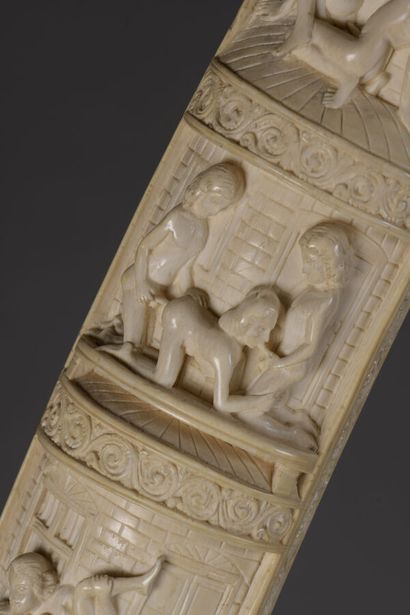 null Tusk in carved ivory with erotic themes. Metal frame, base in the shape of an...