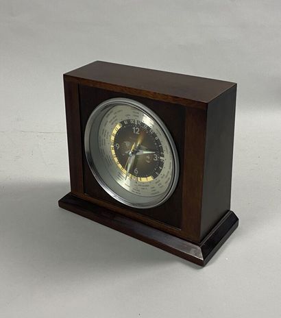 null Clock with time zones, the case in varnished wood, the frame in metal. With...