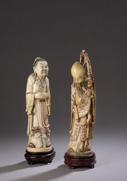 null Lot of two carved ivory subjects enhanced with red and black ink, an Immortal...
